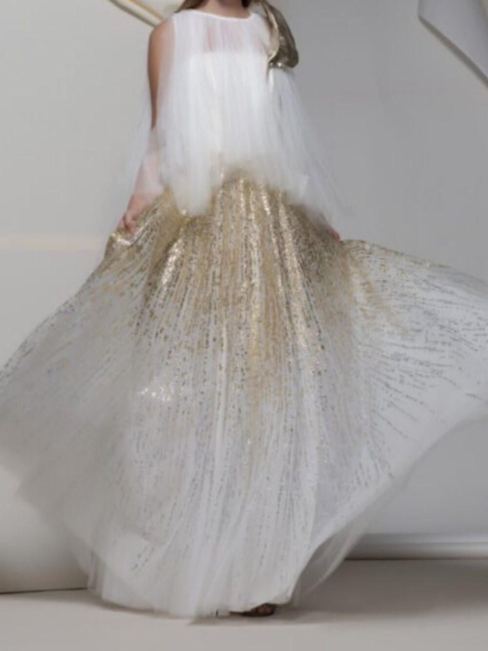 Womans white and gold designer evening gown